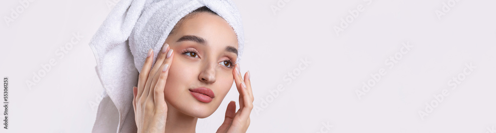 Beautiful girl with thick eyebrows and perfect skin at white background, towel on head, beauty photo. Beautiful girl with thick eyebrows and perfect skin at white background, towel on head, beauty photo.