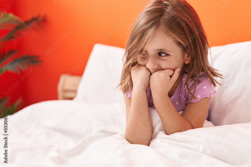 Adorable hispanic girl smiling confident sitting on bed at bedroom Adorable hispanic girl smiling confident sitting on bed at bedroom