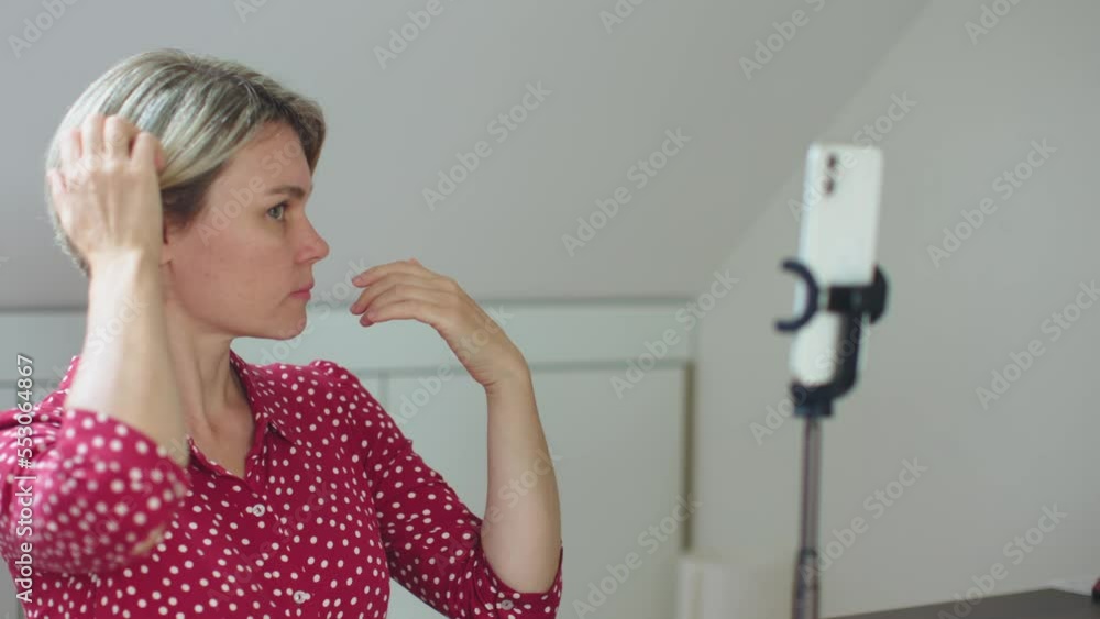 female tutor influencer blogger get ready before recording video on smartphone tripod on table caucasian woman touch screen selfie camera prepare video conference social media content online class female tutor influencer blogger get ready before recording video on smartphone tripod on table caucasian woman touch screen selfie camera prepare video conference social media content online class