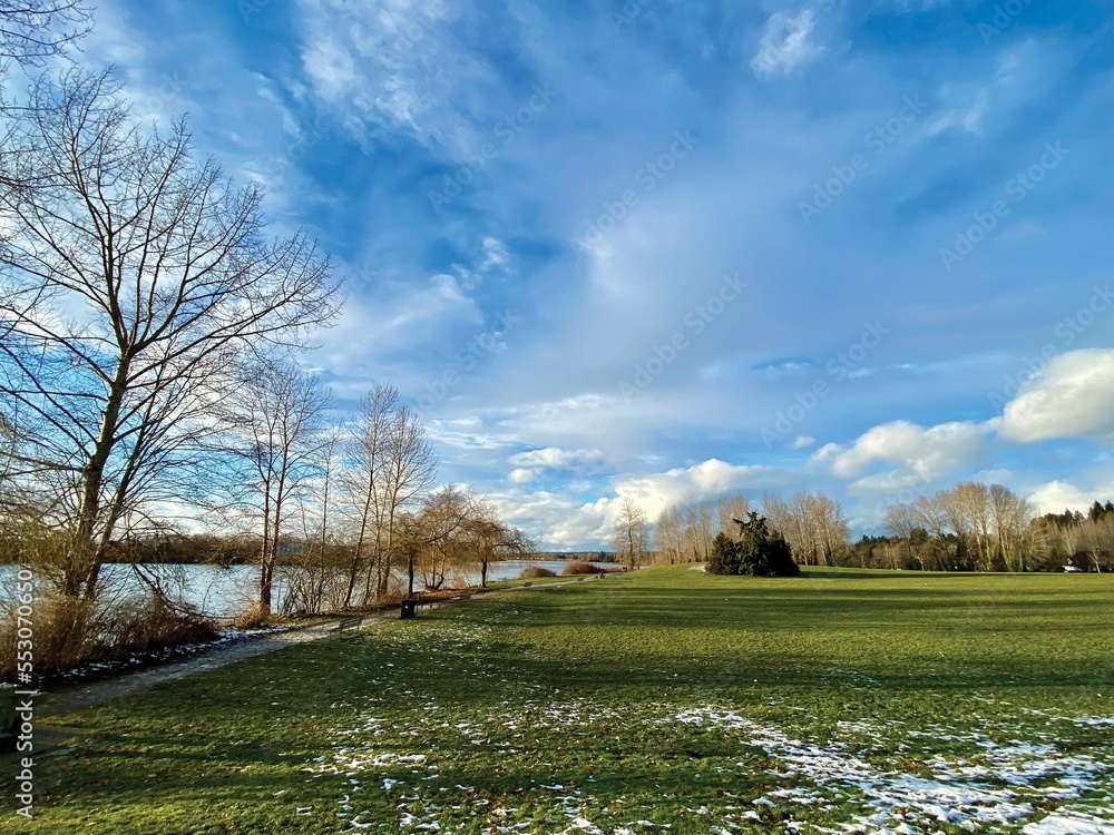 Fraser River Park in Vancouver, British Columbia, Canada. Some area of the field was still covered by snow in the sunny afternoon. Fraser River Park in Vancouver, British Columbia, Canada. Some area of the field was still covered by snow in the sunny afternoon.