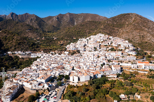 Drone view of the small town with white houses and surrounding countryside, Ojen, Spain in the summer