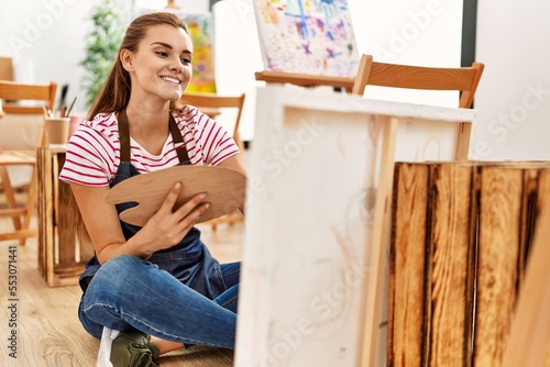 Young woman smiling confident drawing at art studio