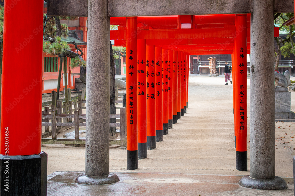 A set of orange gates at Sumiyoshi Temple on a rainy day in November, Fukuoka, Japan A set of orange gates at Sumiyoshi Temple on a rainy day in November, Fukuoka, Japan