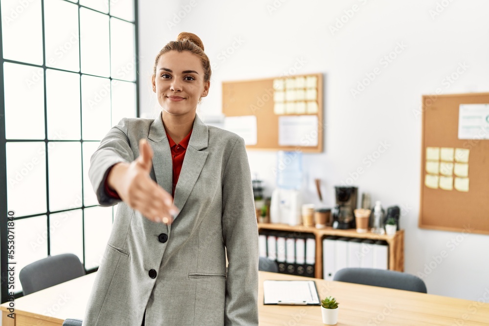 Young woman business worker shak hand at office Young woman business worker shak hand at office