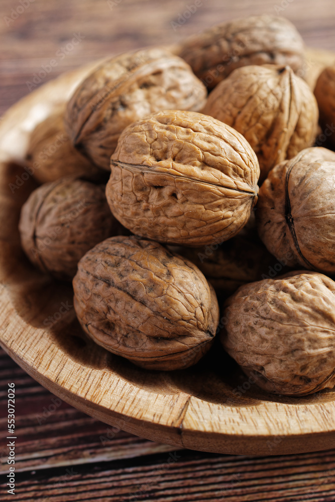 Close up of walnuts in a wooden bowl. Close up of walnuts in a wooden bowl.