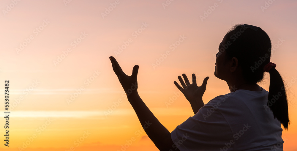 Silhouette of woman hand praying spirituality and religion, female worship to god. Christianity religion concept. Religious people are humble to God. Christians have hope faith and faith in god.
