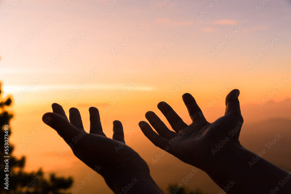 Silhouette of woman hand praying spirituality and religion, female worship to god. Christianity religion concept. Religious people are humble to God. Christians have hope faith and faith in god.