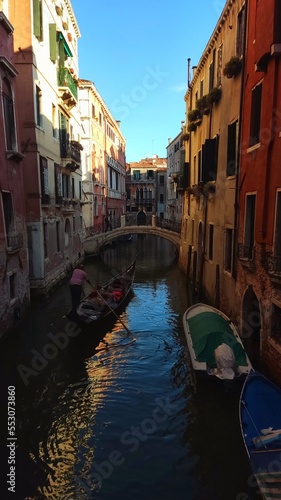View of the Venetian Canal on a sunny day, buildings and boats. Venice, Italy © Irina Satserdova