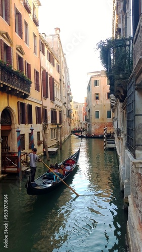 View of the Venetian Canal on a sunny day  buildings and boats. Venice  Italy