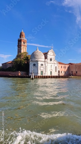 View of the sea pier with a white yacht moored to a wooden bridge, Italy, Venice