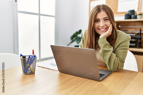 Young hispanic woman smiling confident working at office