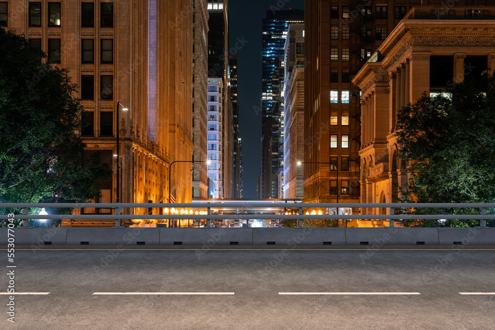 Fototapeta premium Empty urban asphalt road exterior with city buildings background. New modern highway concrete construction. Concept of way to success. Transportation logistic industry fast delivery. Chicago. USA.