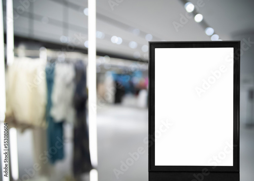 Blank advertising board in clothing store. Mockup for design
