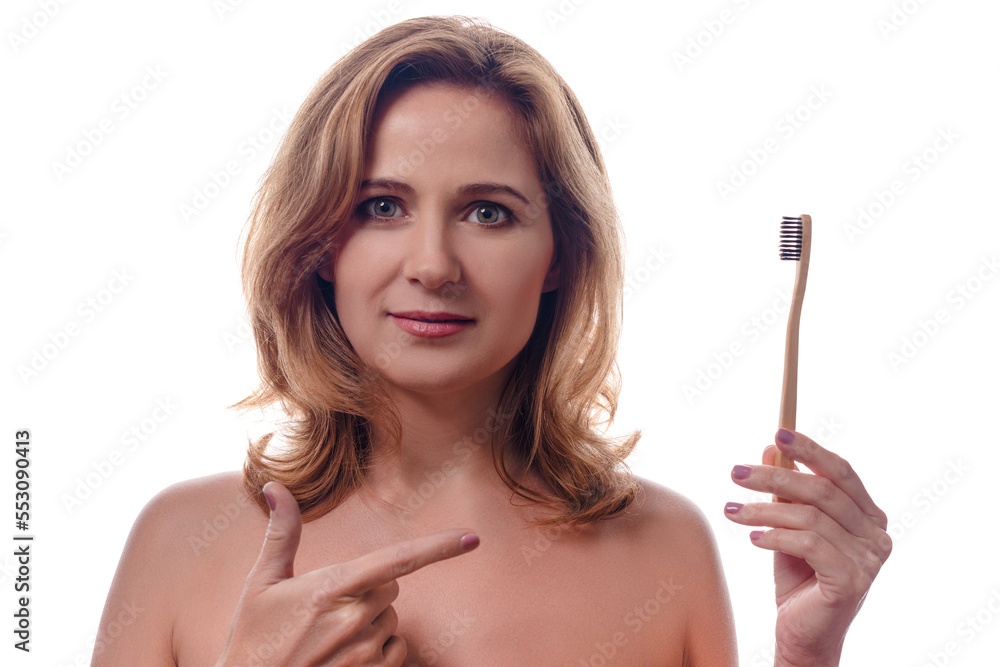 dental care, oral hygiene and people concept - portrait of happy smiling woman holding wooden toothbrush over white background dental care, oral hygiene and people concept - portrait of happy smiling woman holding wooden toothbrush over white background