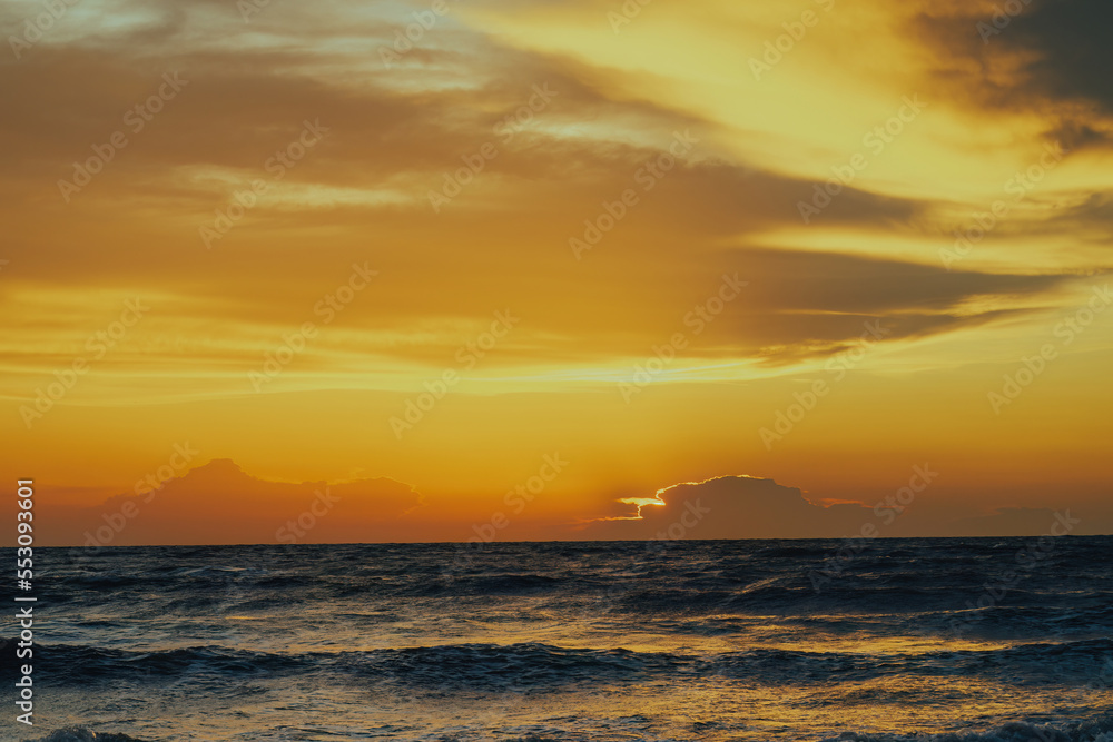 View of the golden sunset near the sea.