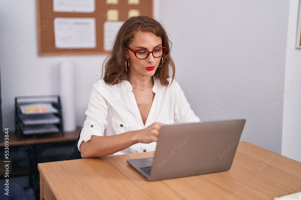 Young beautiful hispanic woman business worker using laptop working at office Young beautiful hispanic woman business worker using laptop working at office