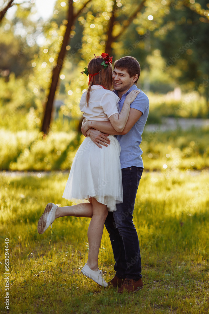 Fototapeta premium Loving couple in casual clothes in the park in summer. 