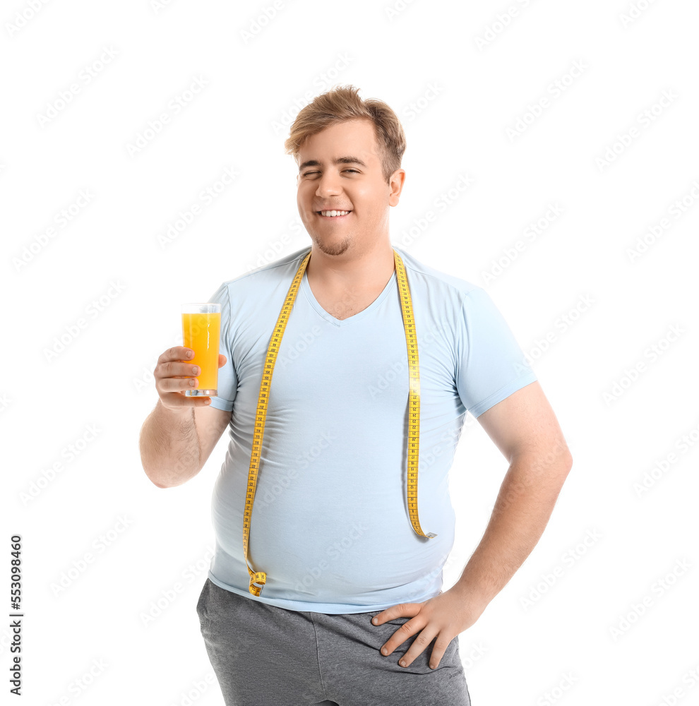 Young overweight man with measuring tape and glass of juice on white background Young overweight man with measuring tape and glass of juice on white background