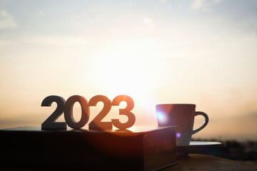 The brightly rising sun, books, coffee cups, and brilliant sunrise scenery
