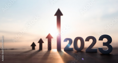 High rising arrow and bright rising sun 2023 new year sunrise and stock finance economy industry growth investment target concept 