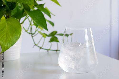 a glass of cold water on white table. 