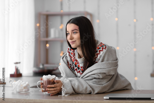 Young woman with glass cup ...