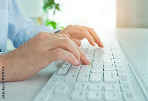 Male office worker typing on the keyboard