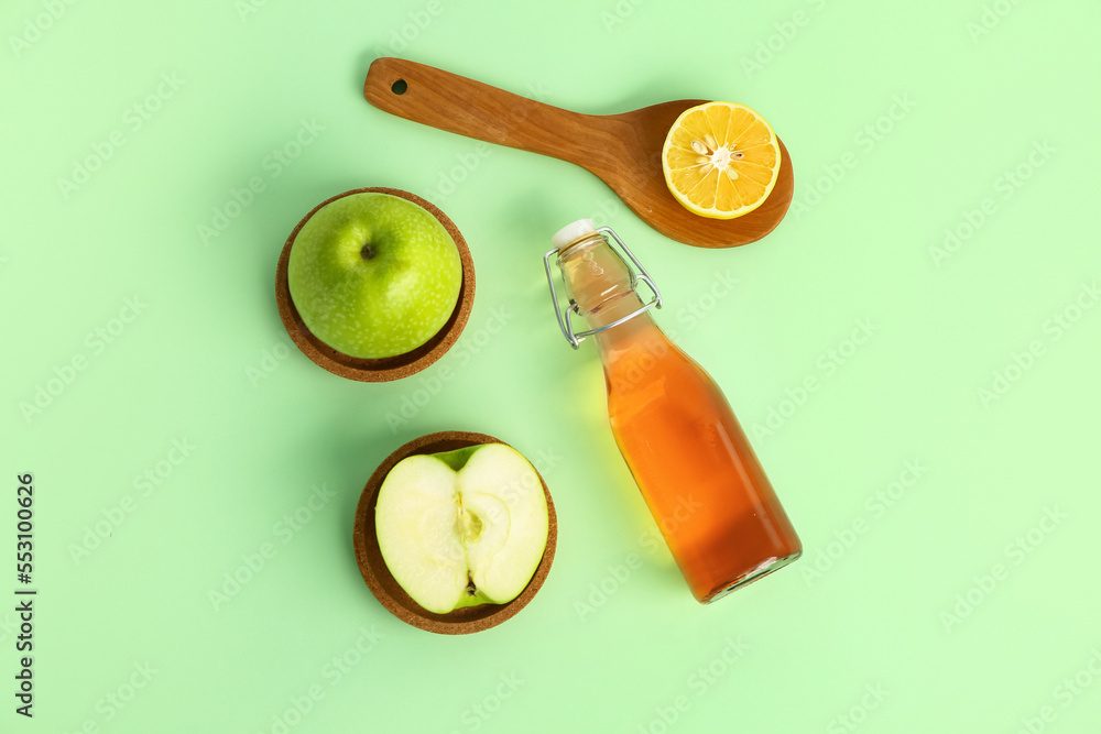 Composition with bottle of apple cider vinegar and fresh fruits on color background Composition with bottle of apple cider vinegar and fresh fruits on color background