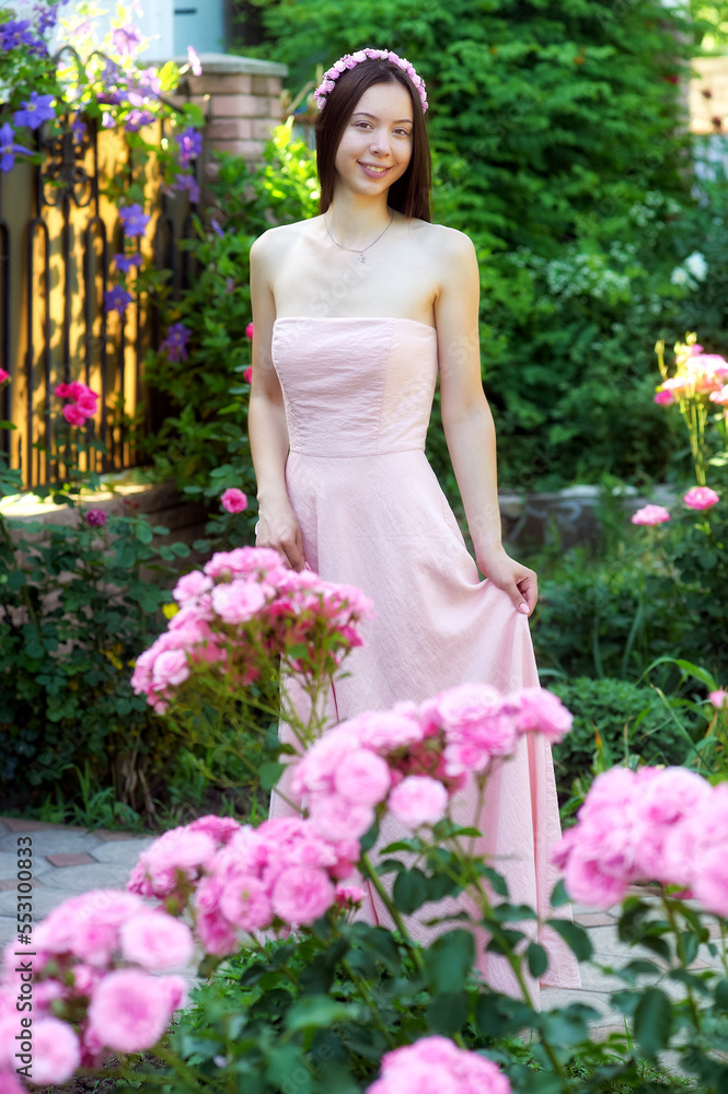 Young woman in pink dress outdoors