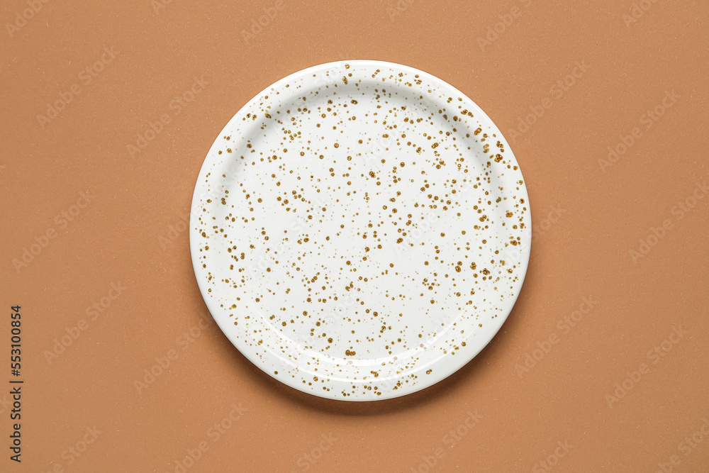 Empty stylish plate on brown background Empty stylish plate on brown background