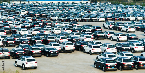 New cars parked at distribution center, automobile factory