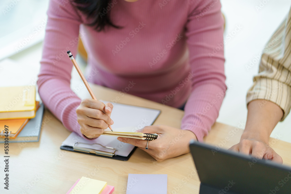 Businesspeople consulting on investment project work and marketing strategy planning and using a calculator and documentation. Businesspeople consulting on investment project work and marketing strategy planning and using a calculator and documentation.