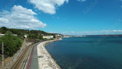 Wallpaper Mural Train driving on the seafront of sunny Caxias, Lisbon, Portugal - Aerial view Torontodigital.ca