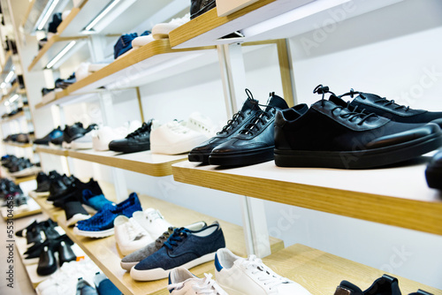 Male shoes on wooden shelf in the store