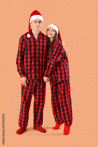 Young couple in Santa hats ...