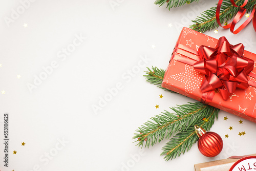 Gift box with Christmas branches on white background, closeup