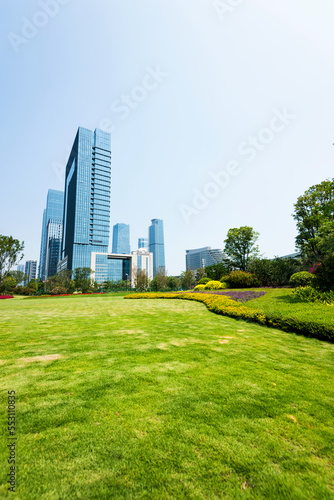 Green park next to business center buildings