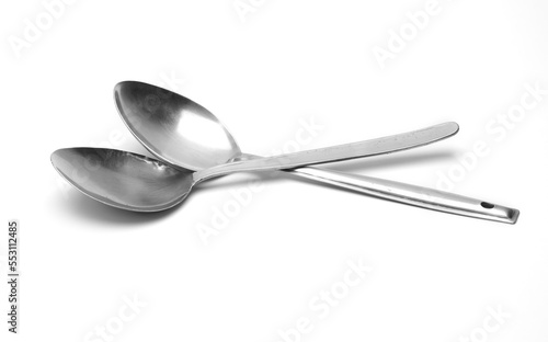 Two old used silver spoons on isolated white background