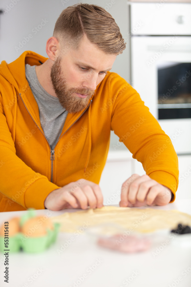 handsome man cooking at the kitchen handsome man cooking at the kitchen