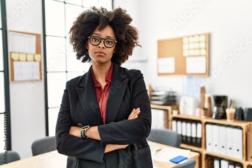 Young african american woman standing with arms crossed gesture at office