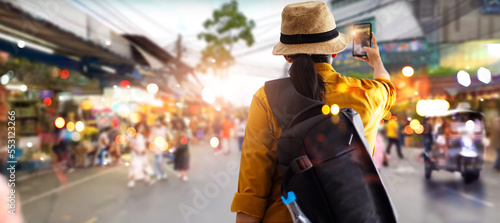 Female tourist traveling backpacker and take a photo in jatujak, chatuchak outdoor market in Bangkok, Thailand photo
