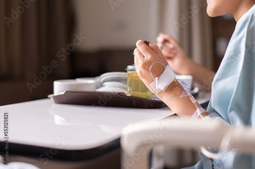 Sick woman patient eating food on sick bed at the hospital