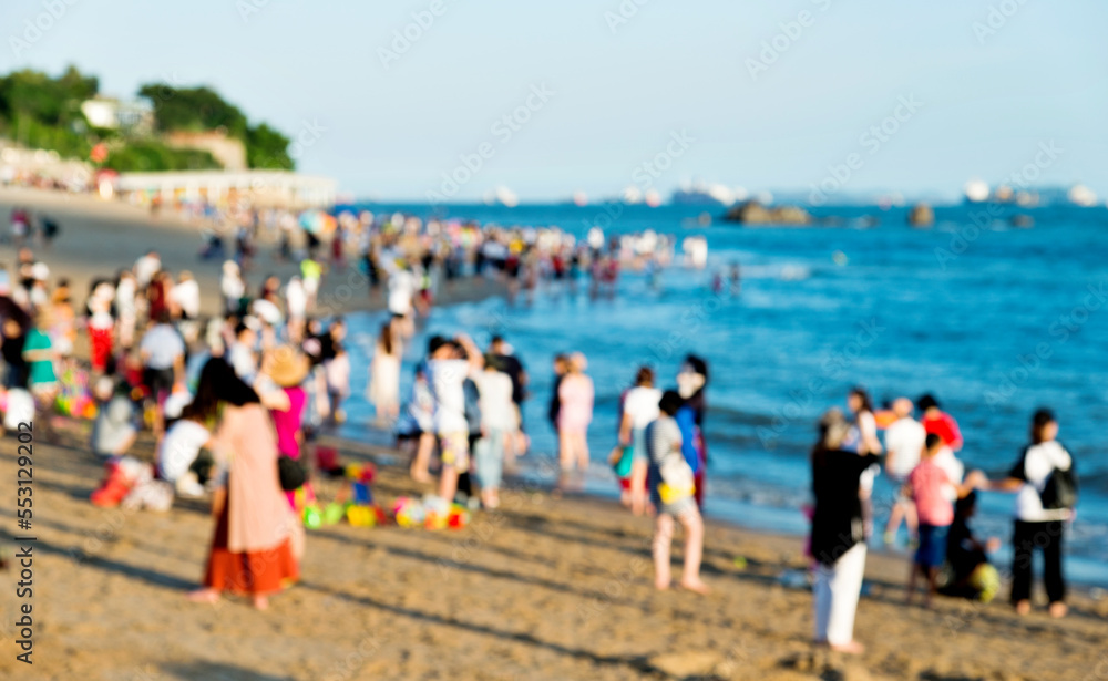 Blurred people having beach party in summer vacation