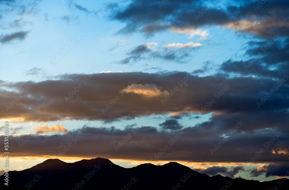 Beautiful sunset sky with clouds in mountains