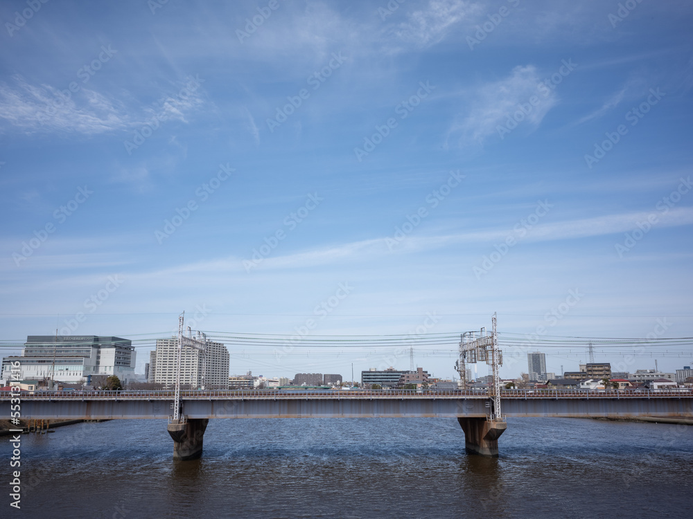 train bridge on the river and blue sky in katsushika ward