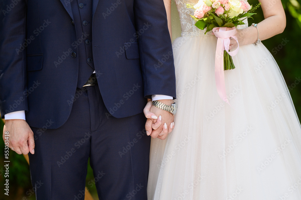 Close-up of a married couple, the bride and groom holding hands. Excitement before the wedding. Wedding day Close-up of a married couple, the bride and groom holding hands. Excitement before the wedding. Wedding day