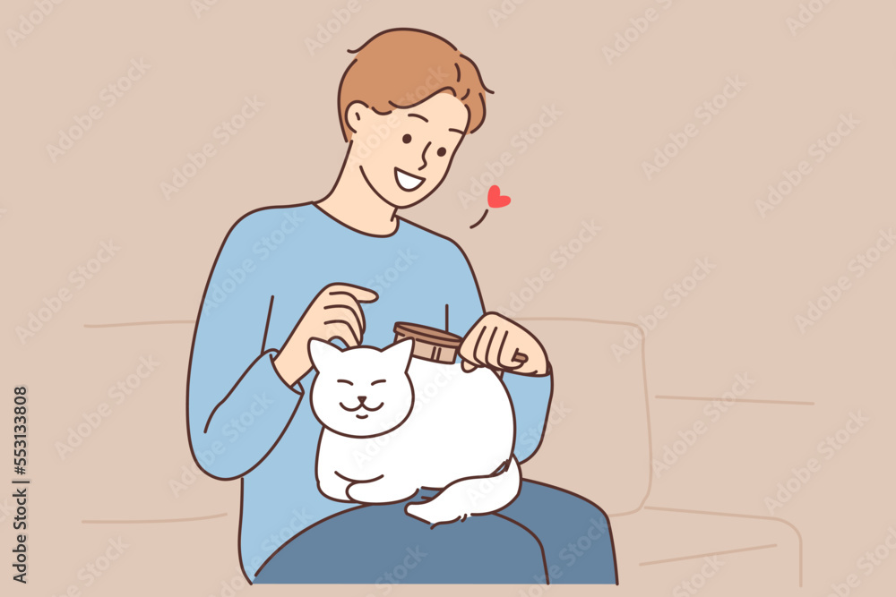 Happy man brushing cute cat