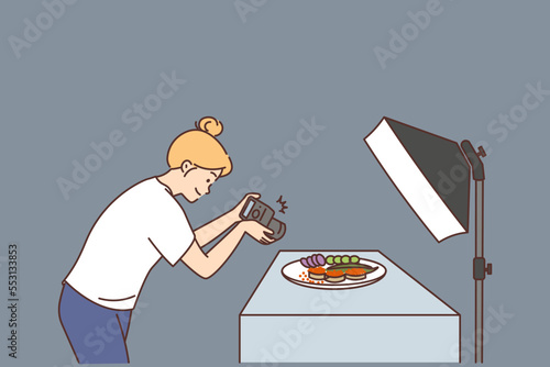 Female photographer take picture of food in studio 