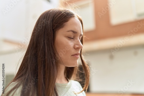 Young beautiful woman standing with serious expression at street Free Download Young beautiful woman standing with serious expression at street - GFXLoad