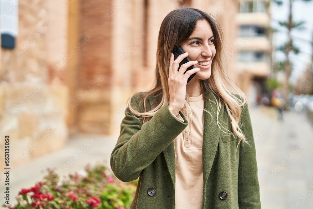 Young woman smiling confident talking on the smartphone at street Young woman smiling confident talking on the smartphone at street